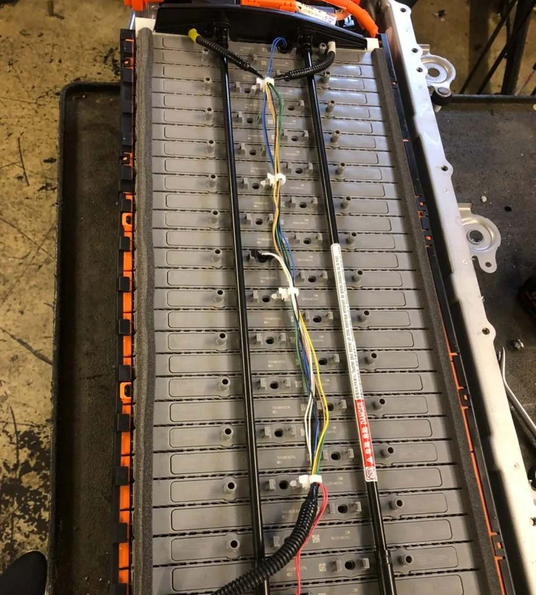 Hybrid battery pack opened on a workshop bench